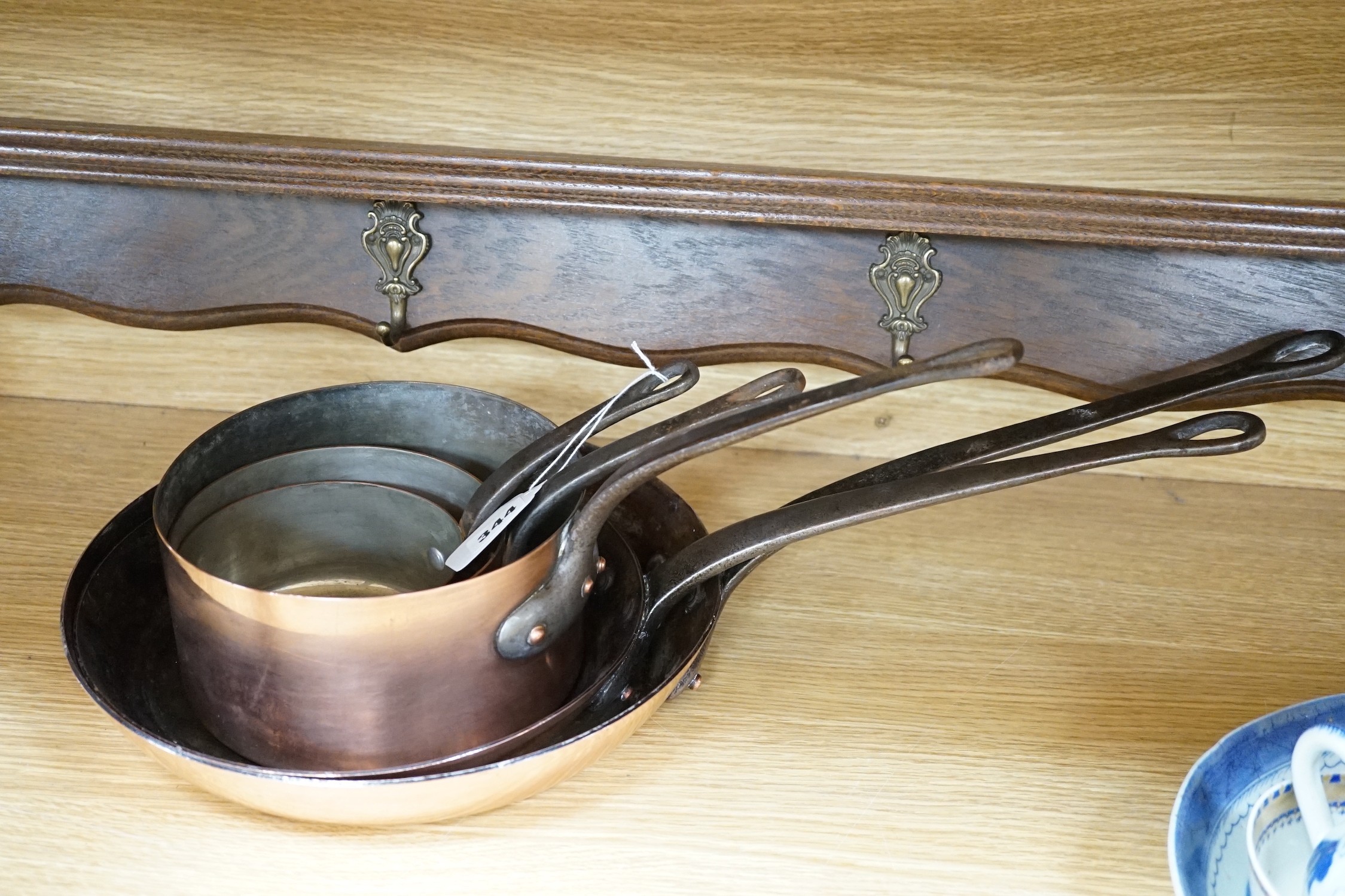 Two copper frying pans by Yves Gautier in Villedieu and three saucepans with an oak 5 hook pan rack